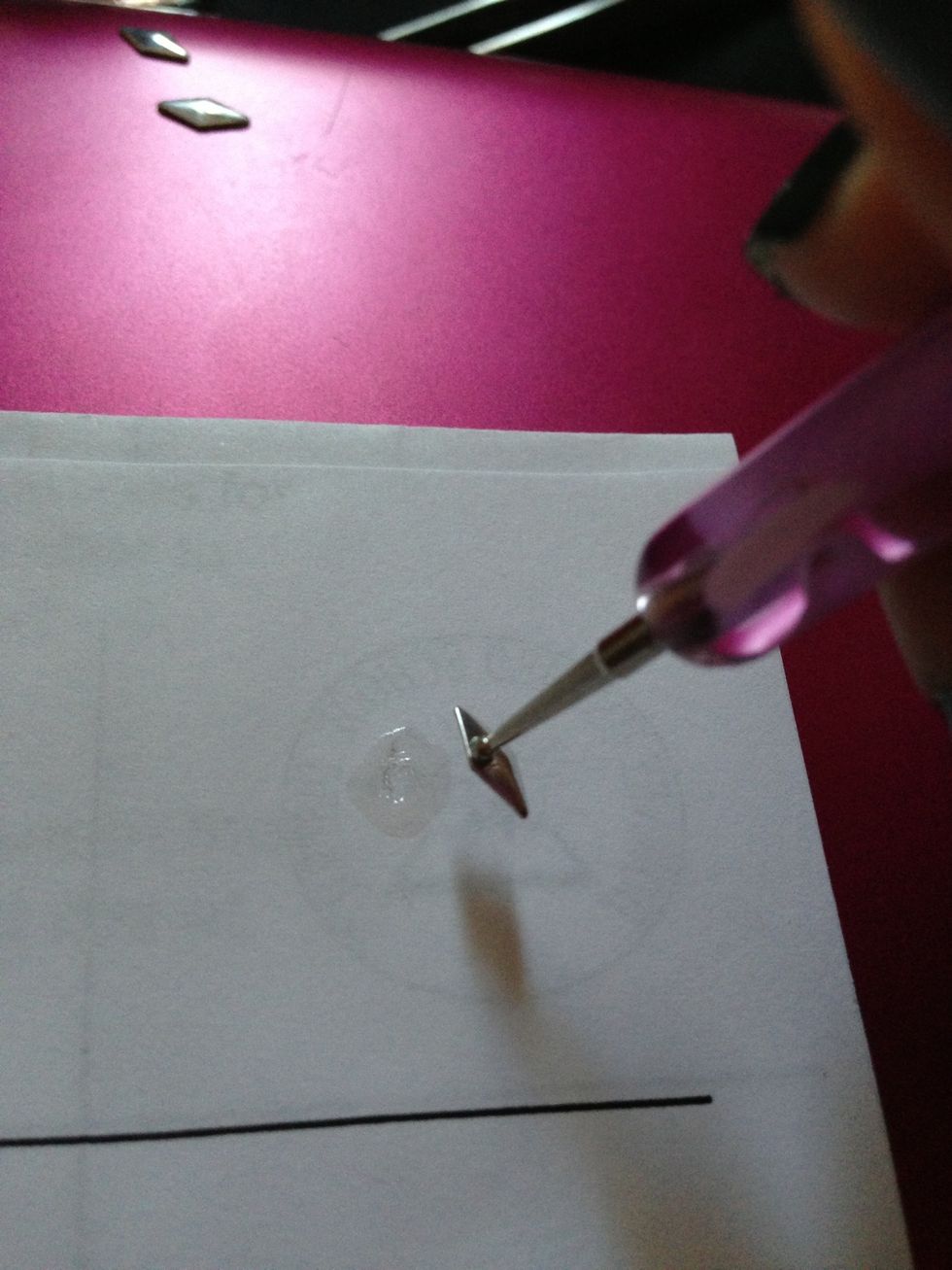 Using ur dotting tool, dip it into the top coat & use it as a glue to pick up ur nail stud. This makes it easy to position on ur nail