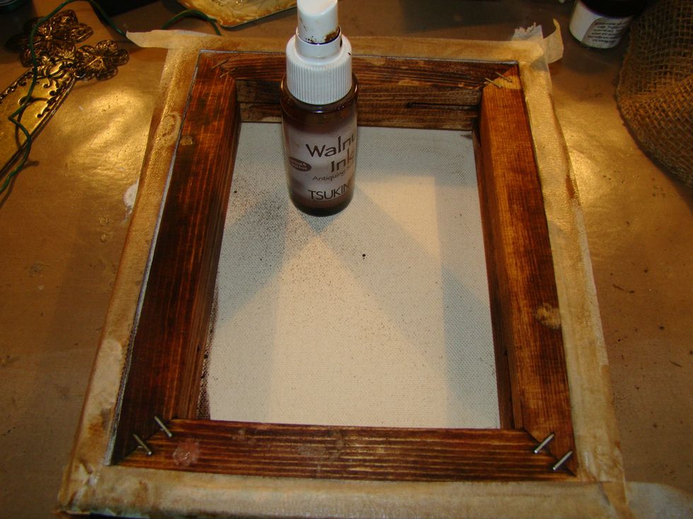 Using Walnut ink, I stained the wood on the inside of the canvas. Be sure to lay a paper towel down inside the canvas so the ink will not seep through to your beautiful back of the canvas.