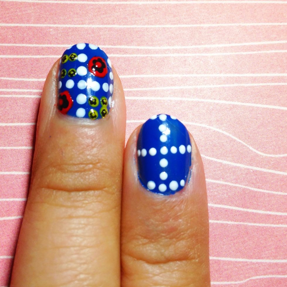 Using white polish and a dotter create a line of dots straight in the centre. Then create two rows of dots in the width of two dots.