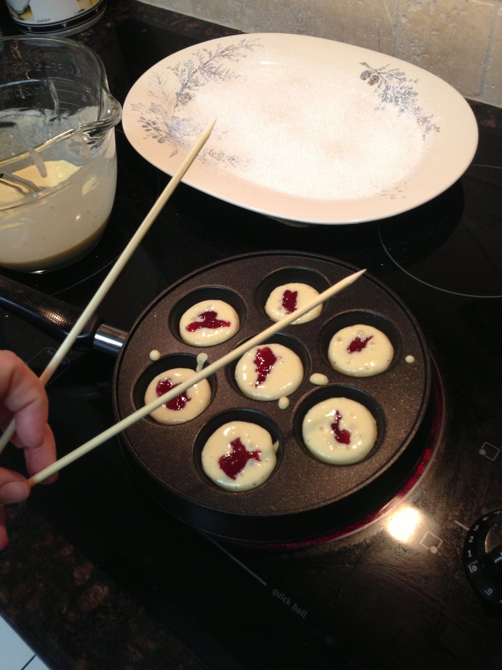 Using wooden skewers, you will turn the pancakes after seeing bubbles rise to the surface of the batter.