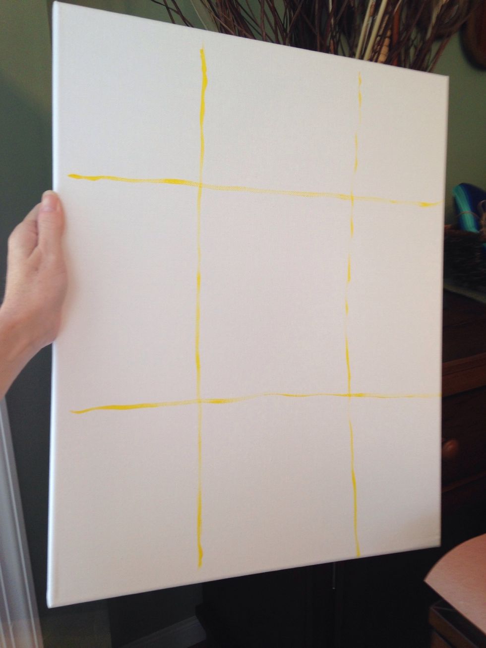 Using yellow paint, create a 9 square grid. Don't worry about your lines being perfect because you will paint over them anyway.