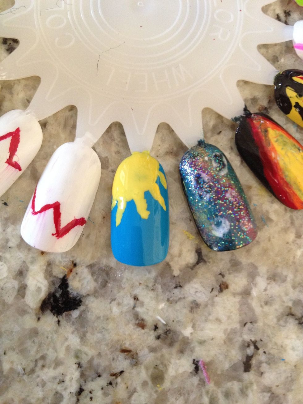 Using yellow polish, make a circle in either the right or left hand corner of your nail and make it as big or as small as you want. Then make lines coming out of it(optional)