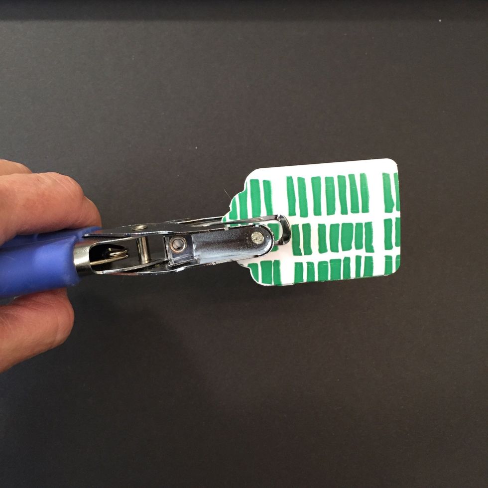 Using you hole punch, make a hole in the top of your tag where you would like the cord to go.