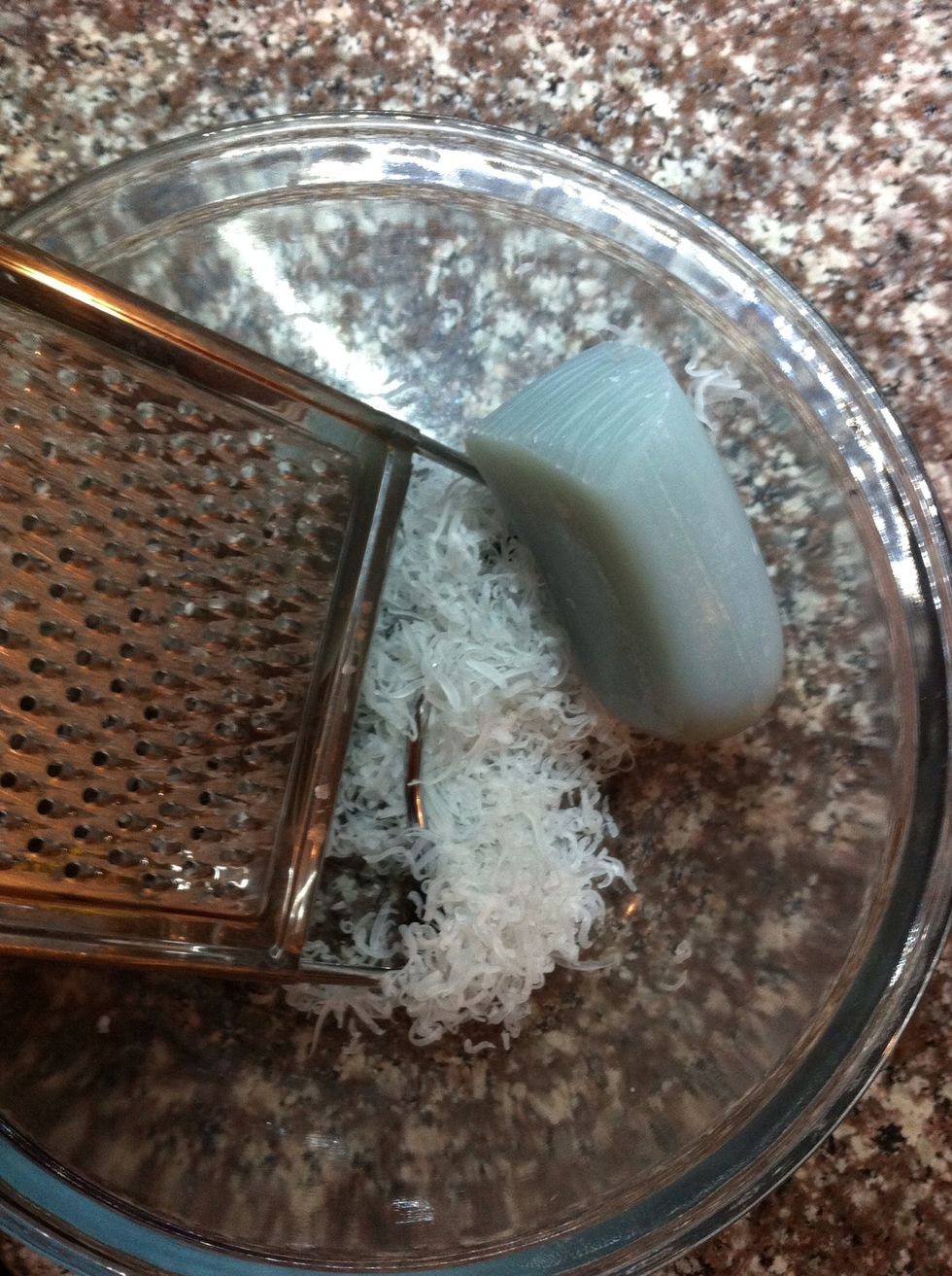 Using your cheese grater, the fine side, grate your soap in your medium sized bowl.