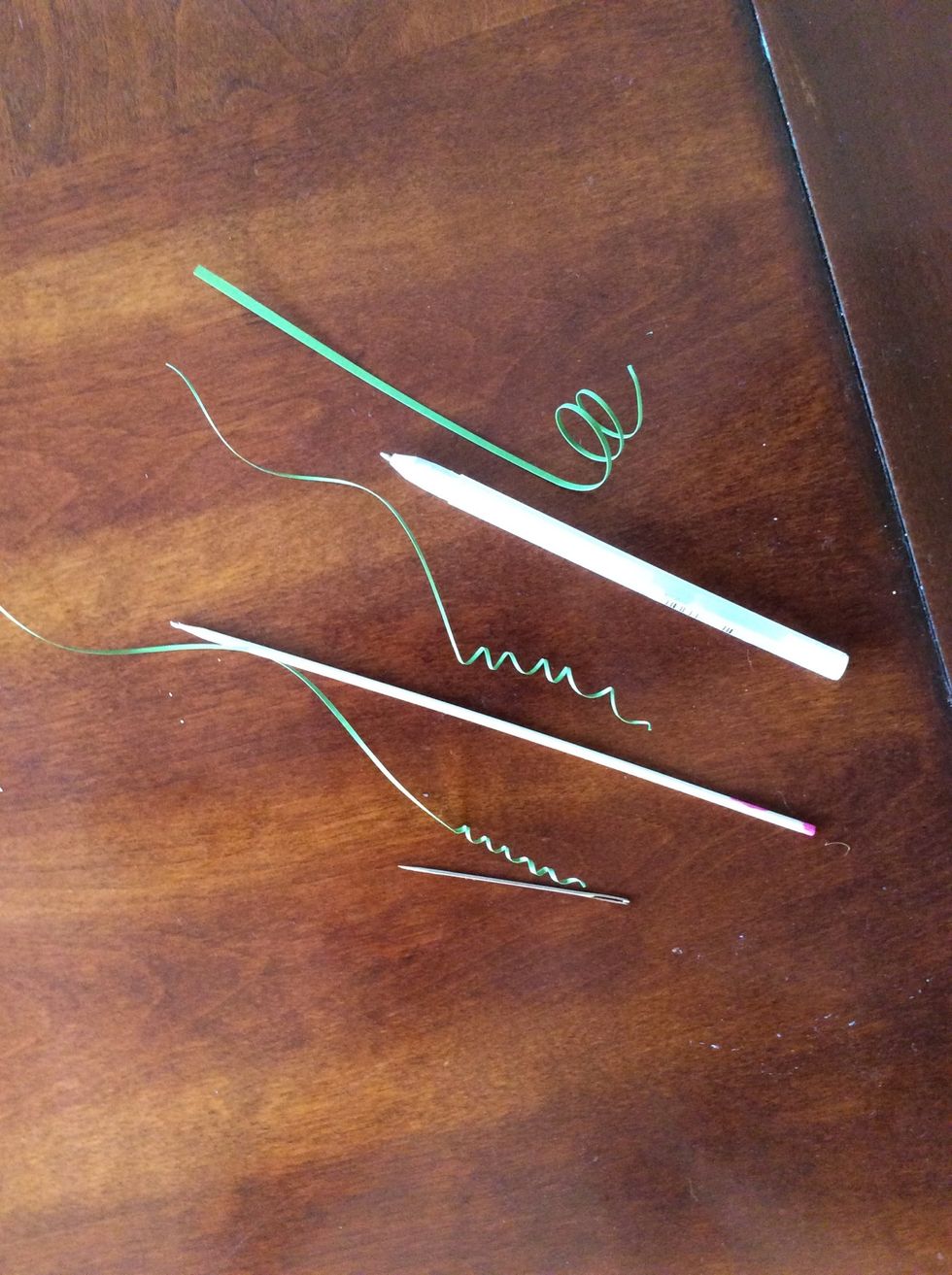 Using your cylindrical object, hold one end of the paper and wrap the paper around the object. Here are examples of a needle, a barbecue skewer and a pen. Different thicknesses=different results.