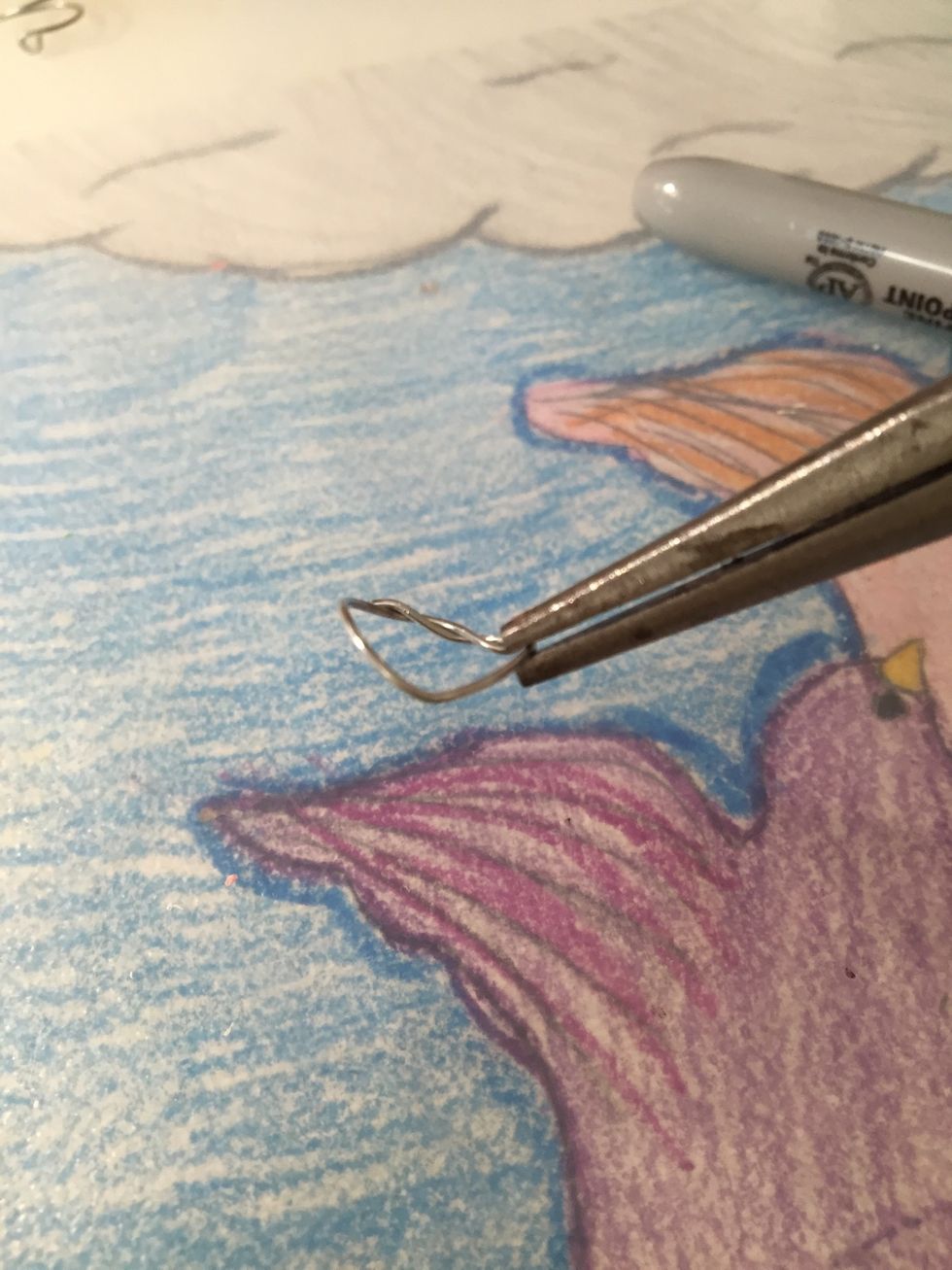 Using your finger press down on the wire OPPOSITE from the twisted wire