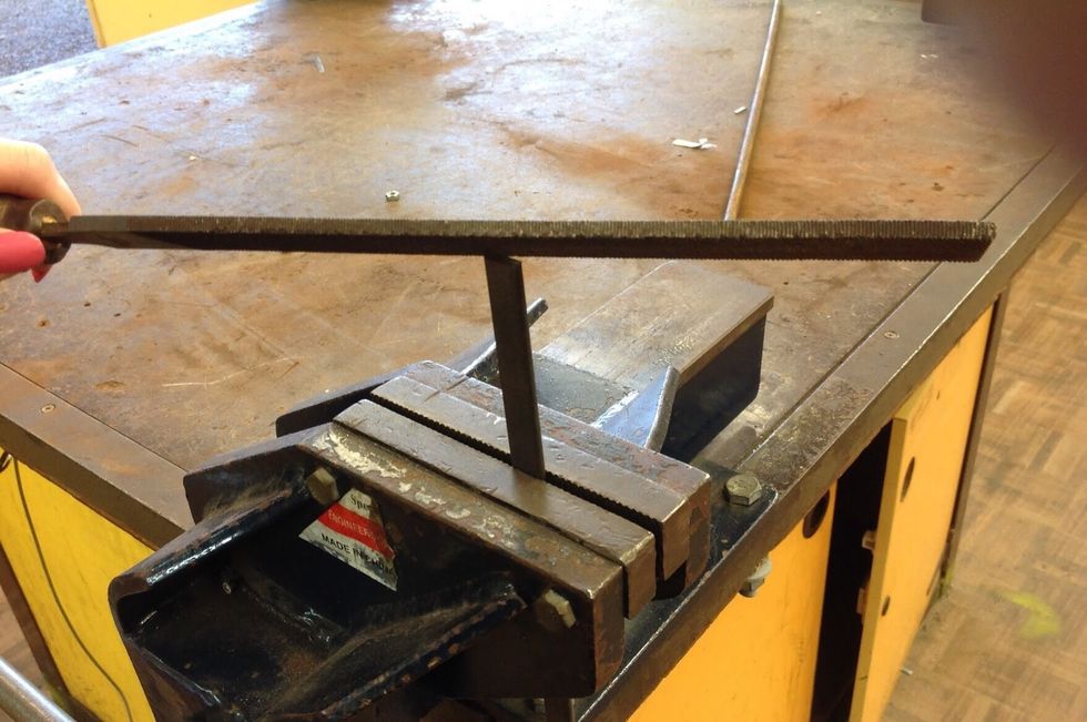 Using your flat bar (20cm x 3mm), file and vice, place your flat bar into the vice and begin to file both ends until smooth.