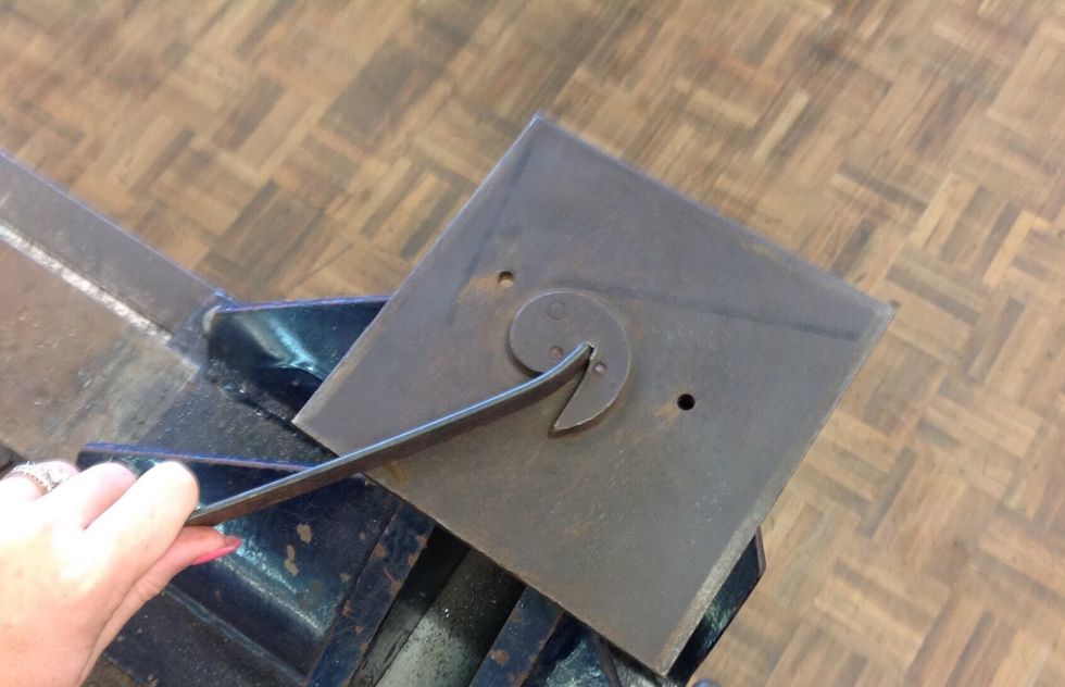 Using your flat bar and scroll plate, place your flat bar into the scroll plate.