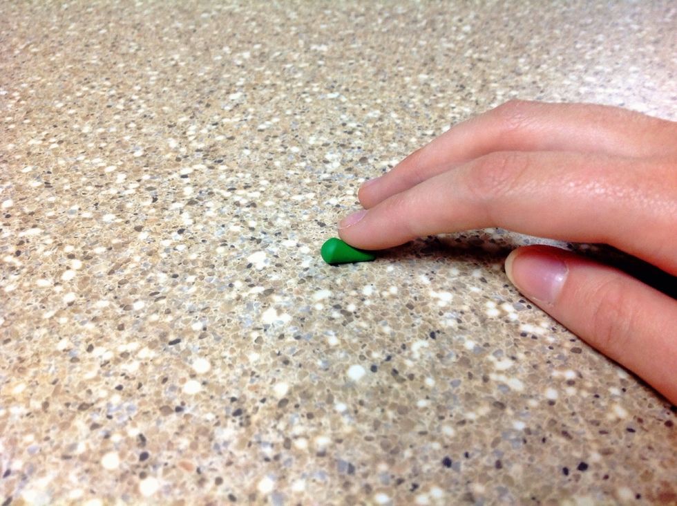 Using your fore finger, press and roll on one side of the ball to make a cone shape.