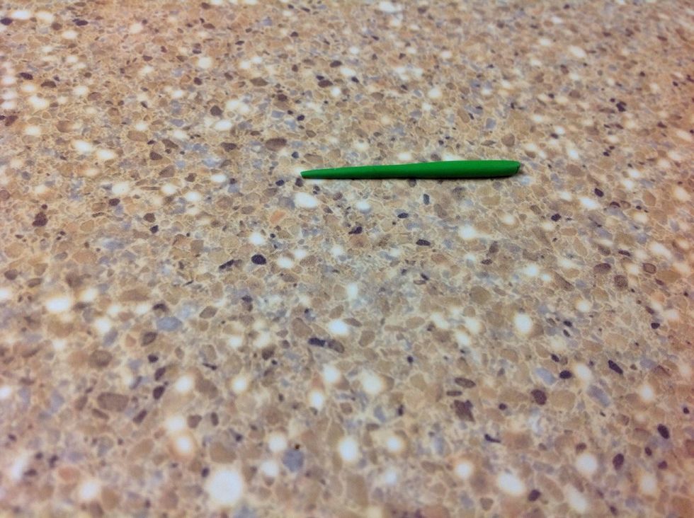 Using your fore finger, roll the clay back and forth on the hard surface to make a snake-like shape. Press harder on one end as you roll to make a point.