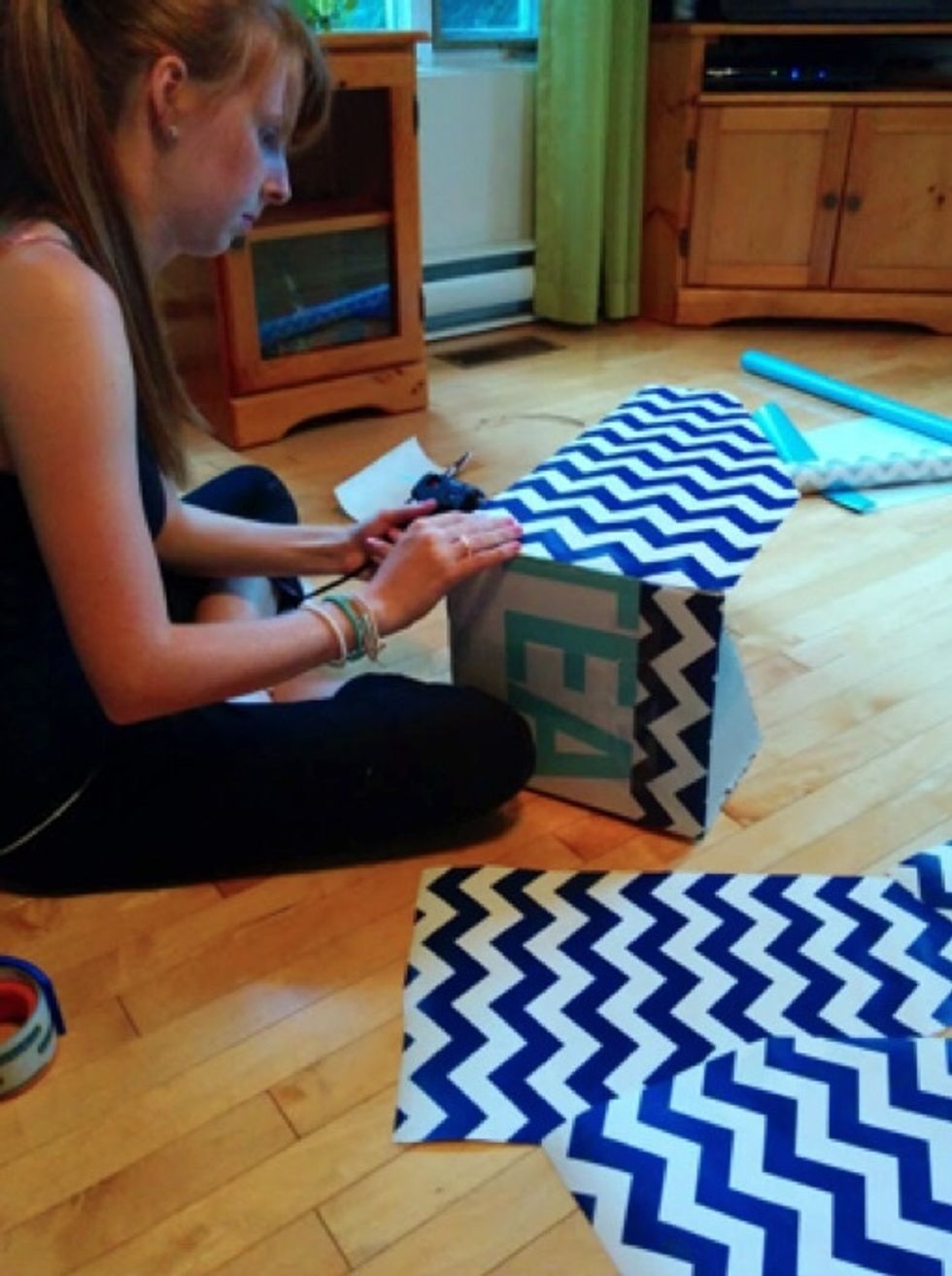 Using your glue gun, glue them to the box.