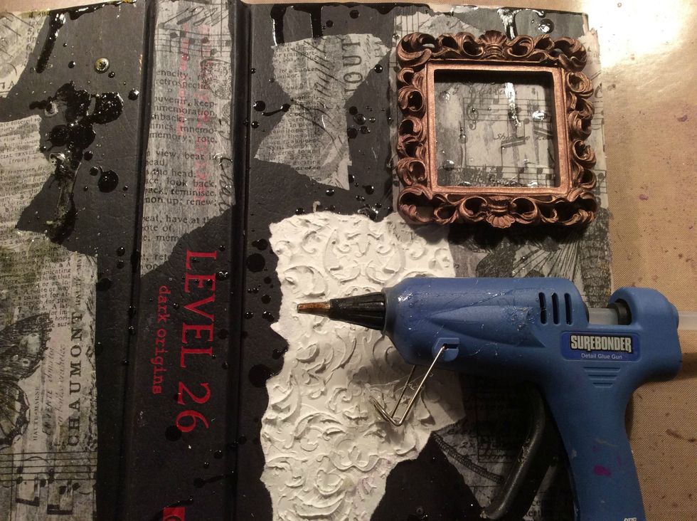 Using your glue gun, randomly draw squiggles, or tree branches or whatever you want on your cover. This is just for more texture. Go ahead and have fun with this. Allow to dry.