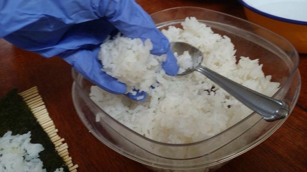 Using your hands, scoop up a handful of rice about the size of your palm.