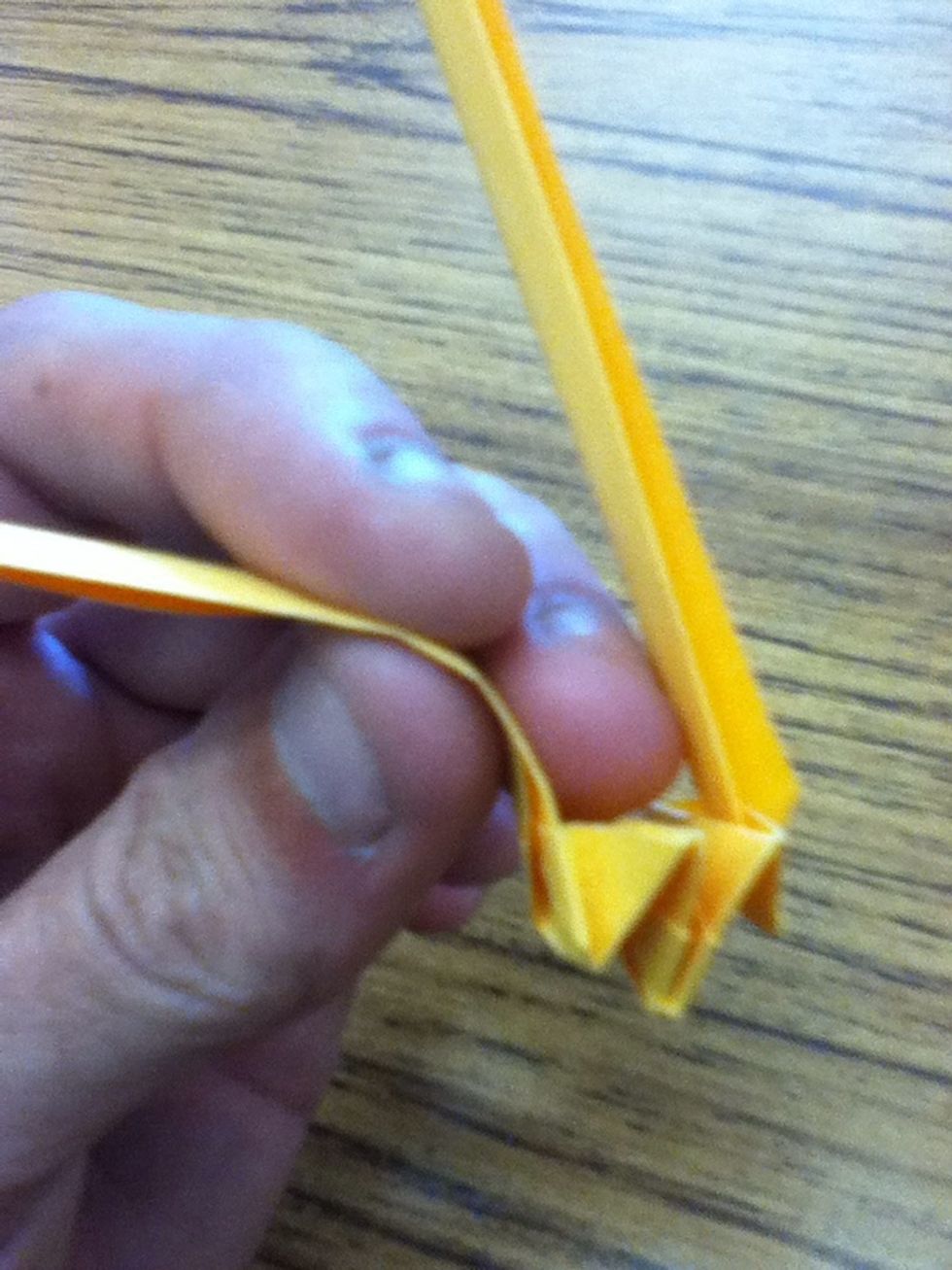 Using your index finger and thumb, carefully squeeze and pull  the ring part so it can make a better loop