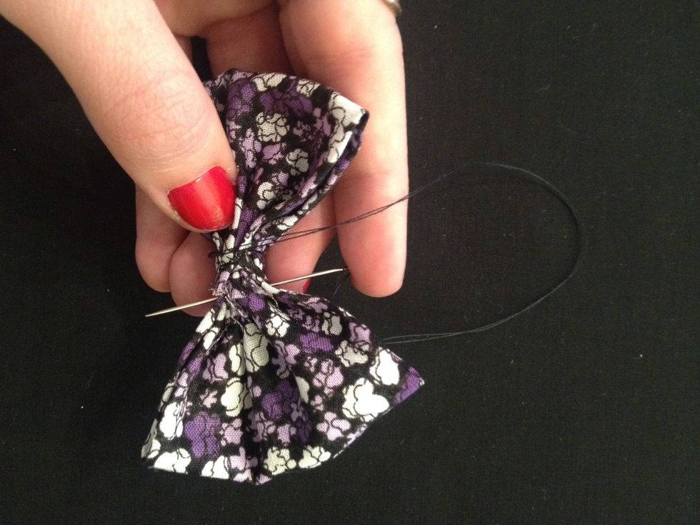 Using your needle and matching thread, sew right where you pinched the fabric to hold it in place.