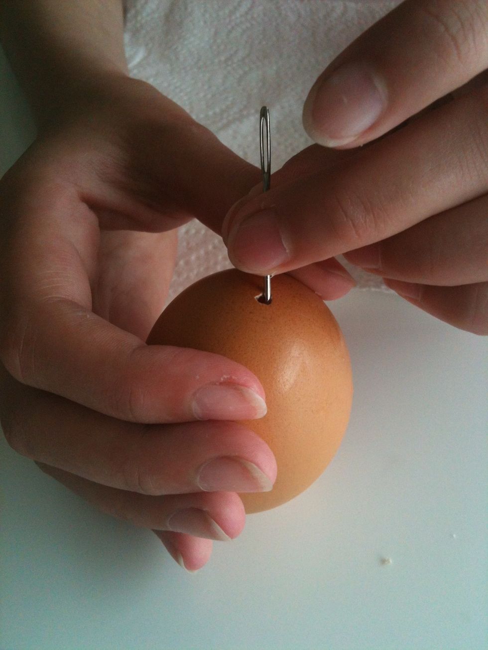 Using your needle carefully make a hole at both ends of the egg. Make the bottom hole a little larger.