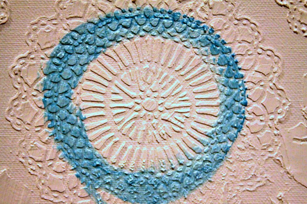 Using your paint brush start painting stenciling in a circular motion onto doily.