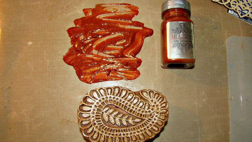 Using your paints with a stamp is easy. Smear a portion on your craftmat and stamp your image randomly. Make sure you clean your stamp thoroughly after stamping.