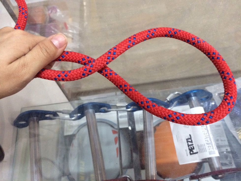 Using your right hand, twist the circular shape of the rope up and away from you (clockwise if you're looking from the right side of your hands toward the left).