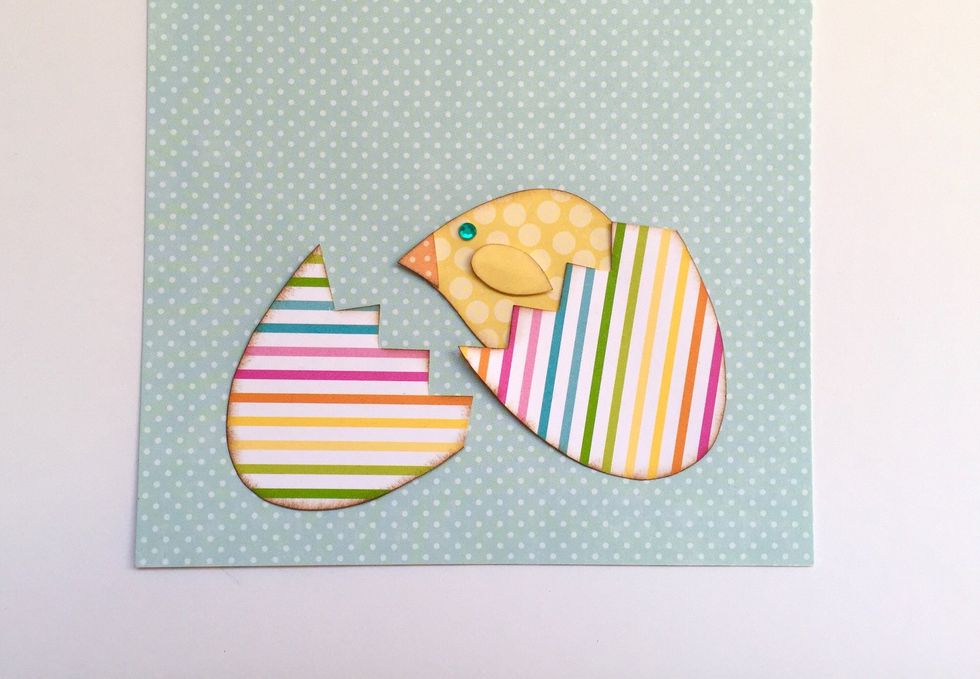Using your scissors, cut your eggshell apart and tuck your little chick in one side of it. So cute!