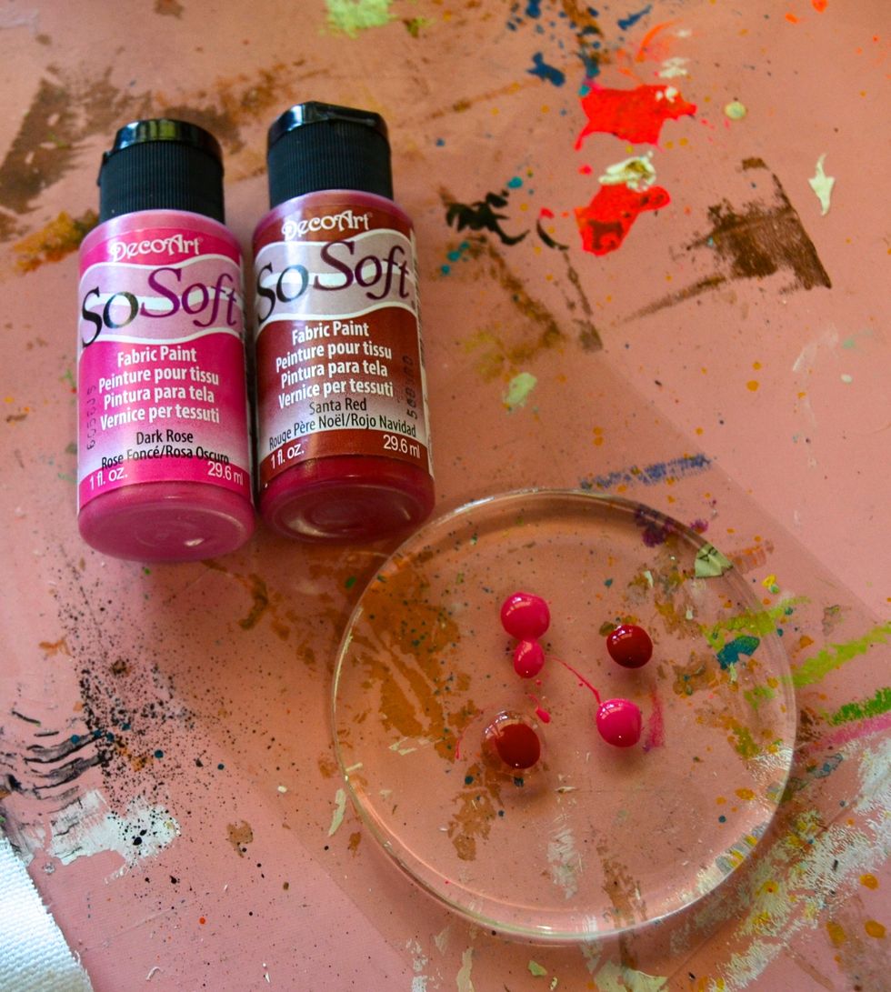 Using your small circle Gel Press\u2122 gel plate, add a few drops of DecoArt So Soft paint. Brayer the paint across the plate and use found materials (lids, skewers, etc) to etch designs in the paint