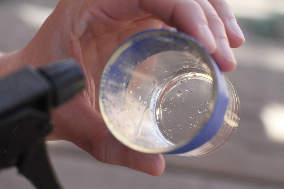 Using your spray bottle of vinegar and water solution (below), lightly spray the inside of your glass. Spraying too much of the solution will cause your paint to run.