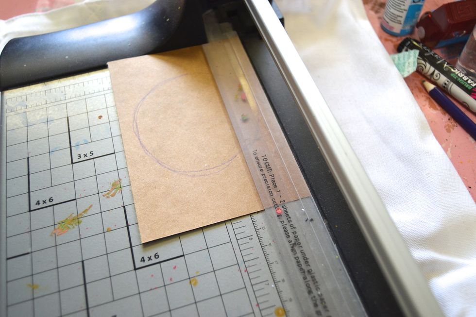 Using your trimmer (for straight lines) cut a perfect square around your circle.