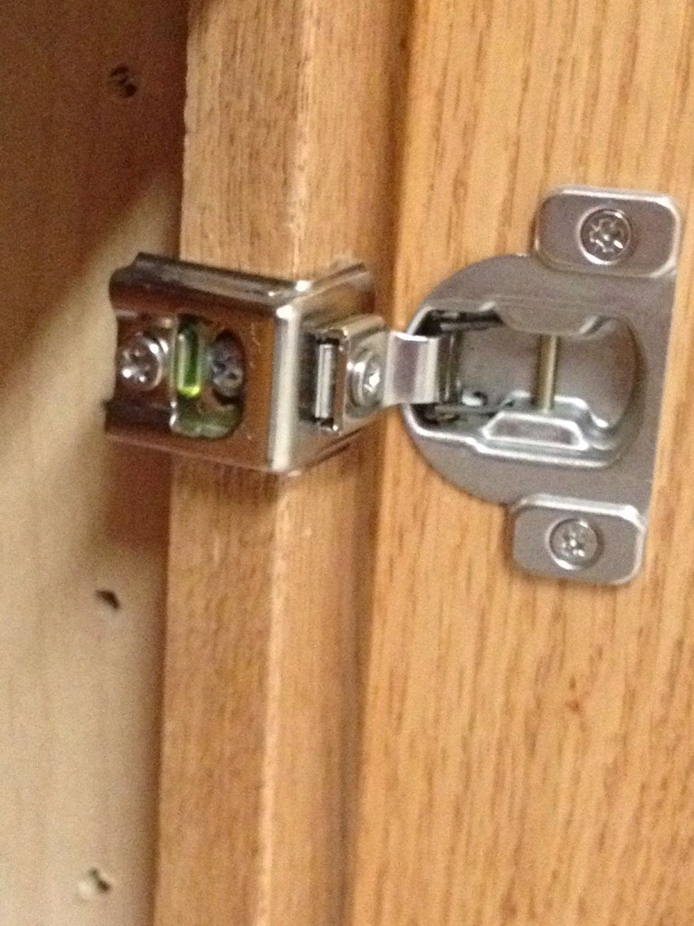 Usually, if the door is loose it will be the screw where it is mounted to the cabinet. With the bracket shown above, it is the screw shown through the inset opening where it is mounted to the cabinet.