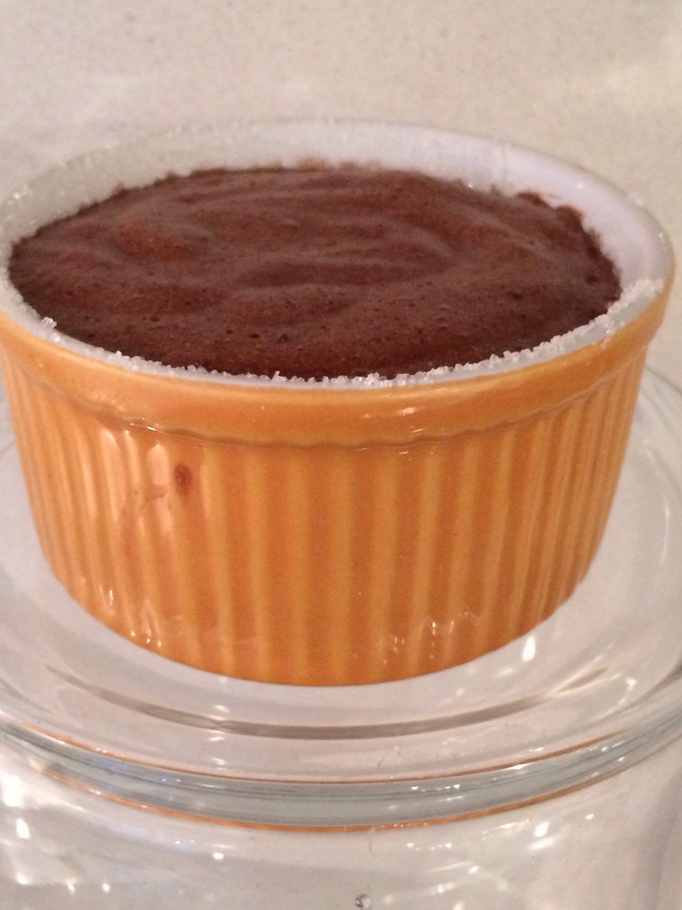 Usually in restaurants the ramekin is filled to the surface.  As you desire but then the edges have to b clean