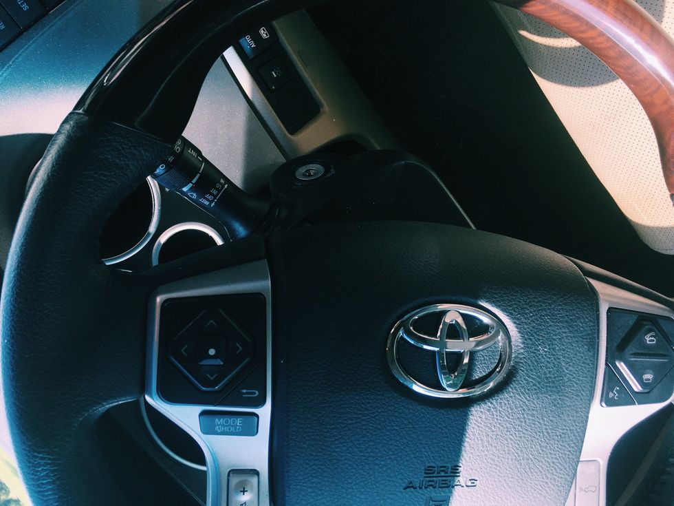 Usually the horn sits right smack in the middle of the steering wheel, but sometimes it may be found in other locations. When you press down it makes a loud sound. Make sure to use this tool wisely:)