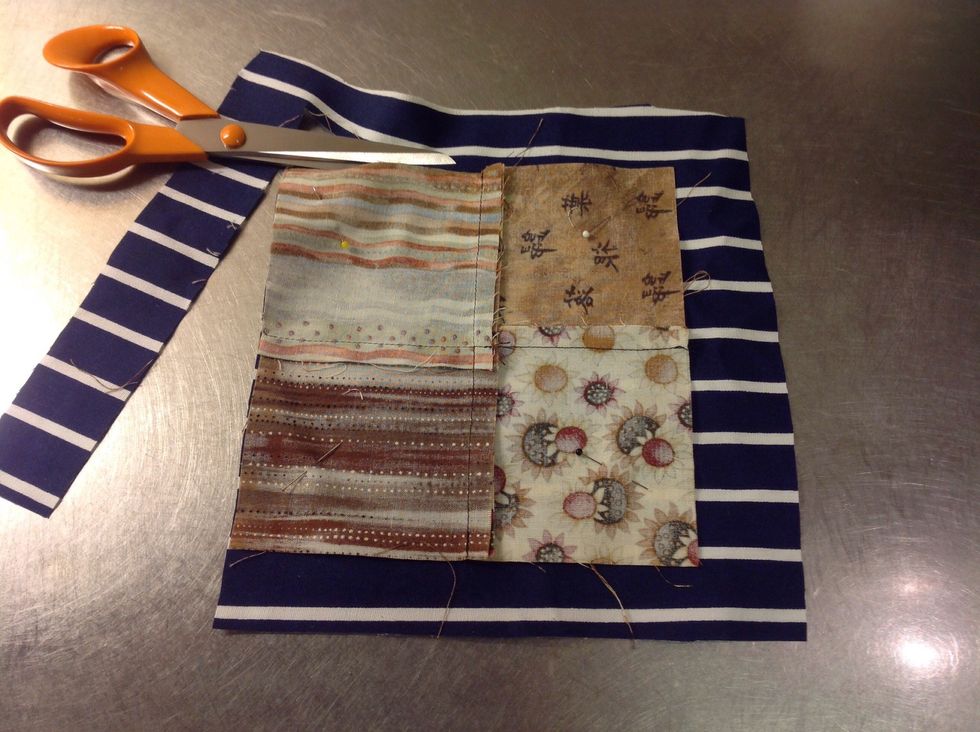 V\u00e4lj ett tyg du vill ha som baksida och l\u00e4gg ut det som p\u00e5 bilden, r\u00e4ta mot r\u00e4ta. N\u00e5la fast och klipp l\u00e4ngs med kanten.