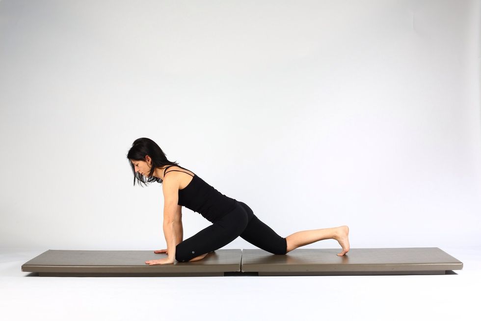 Variation 1. Slide your left knee between your hands and draw your left foot towards right thigh.