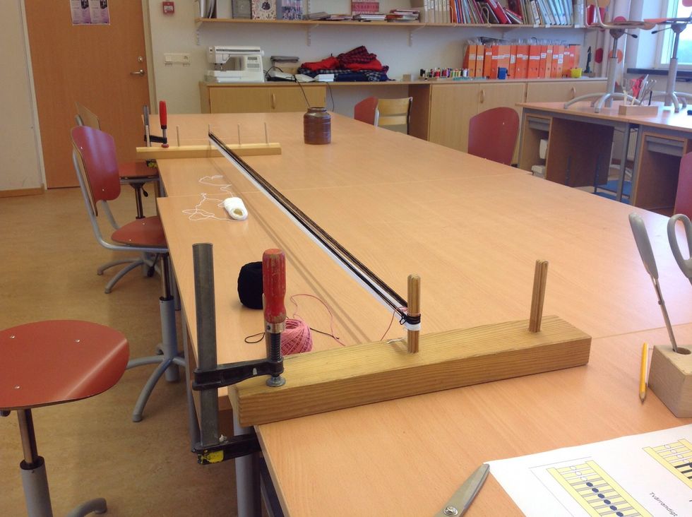 Varpa ditt band. R\u00e4kna hur m\u00e5nga varv du lindar upp. H\u00e4r har jag varpat 8 varv av de tr\u00e5dar som ska vara 16 st, sedan klipps tr\u00e5darna av vid varje pinne, se n\u00e4sta bild.