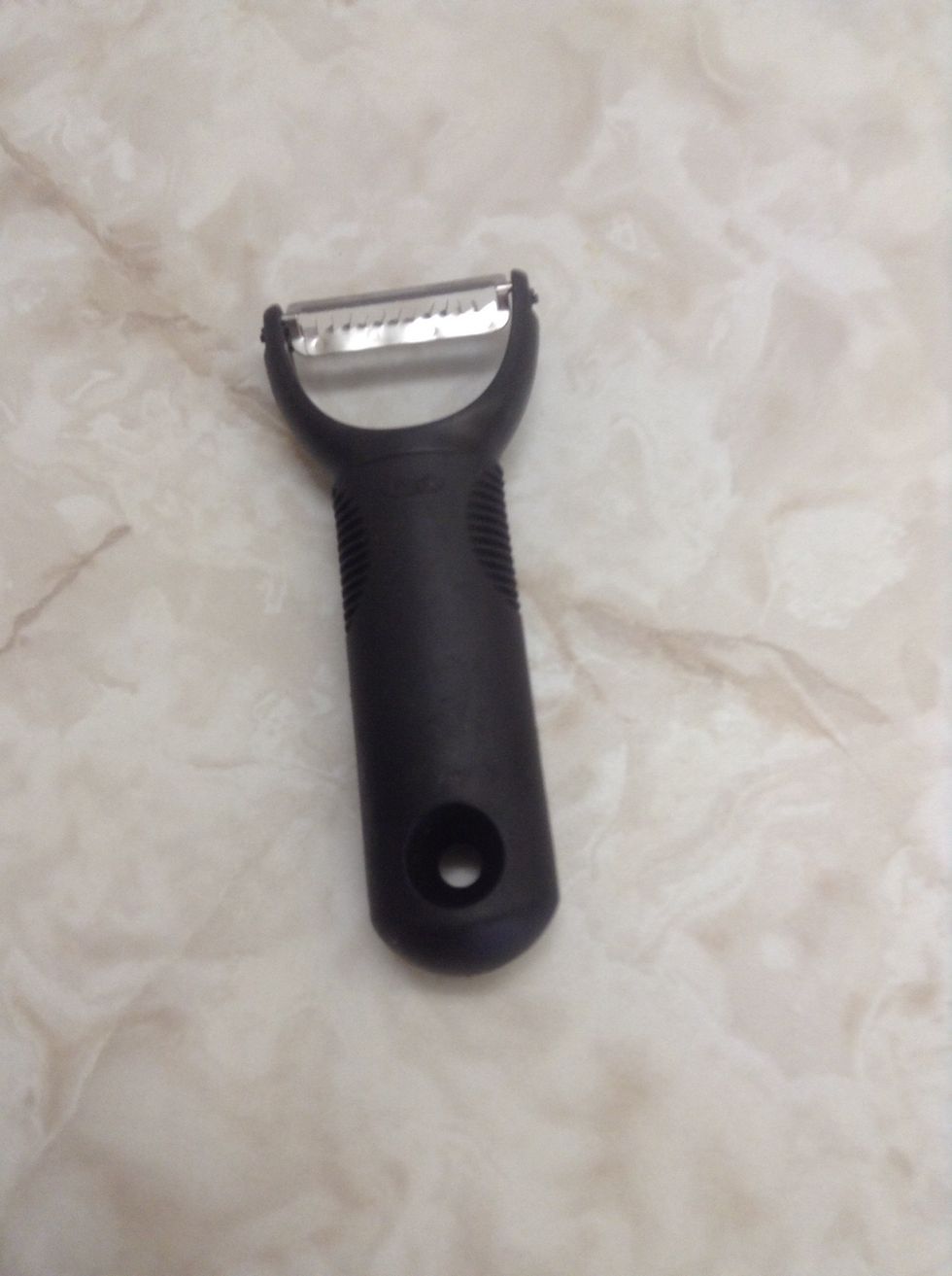 Veggie Peeler. Used for peeling veggies. Also can be used for intimidating enemies (Because it looks like a taser.)I can use a peeler to peel potatoes when my parents are too lazy to do it themselves.