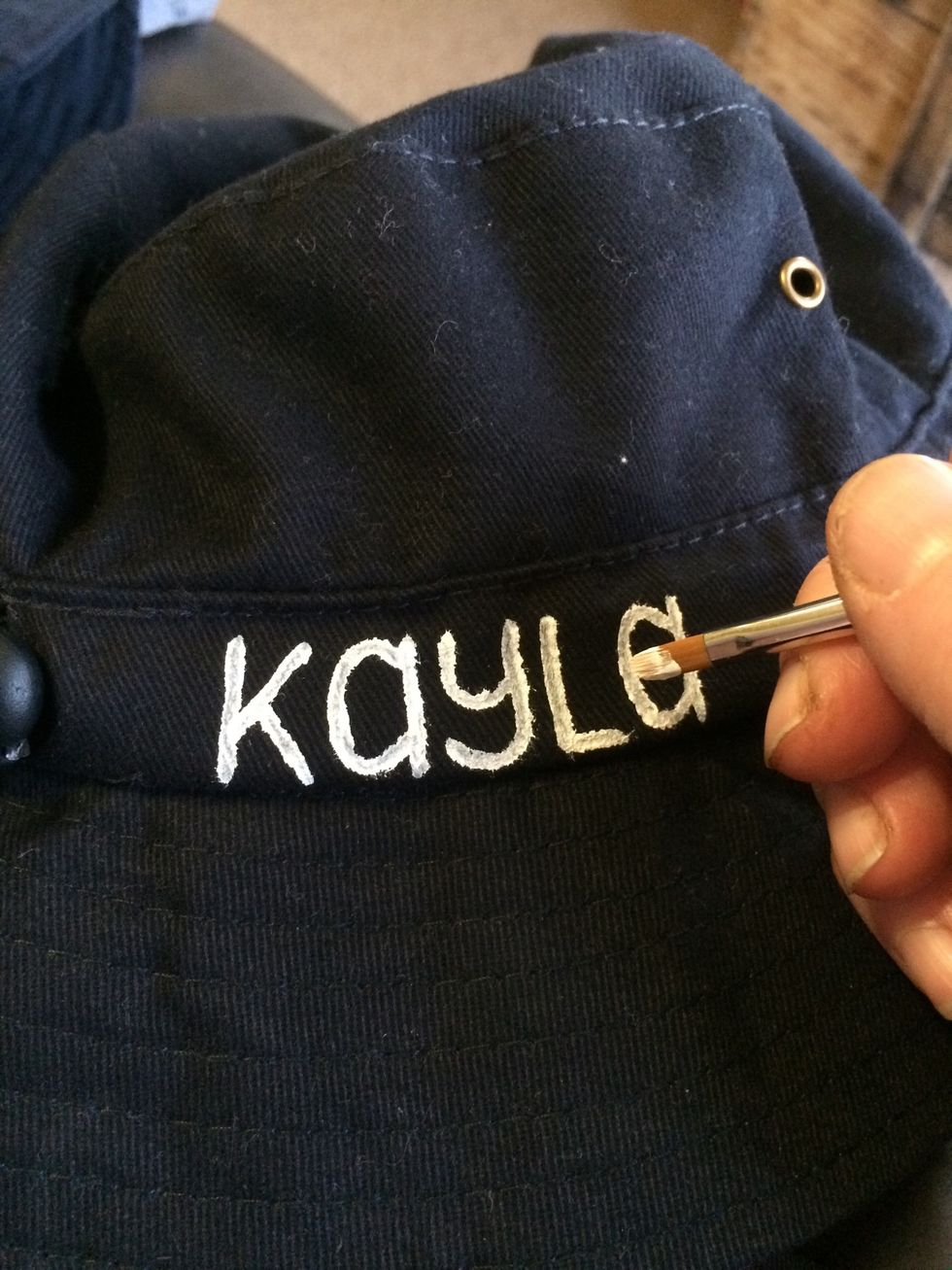 Very slowly and carefully I painted the letters onto the hats using quite a small bush.