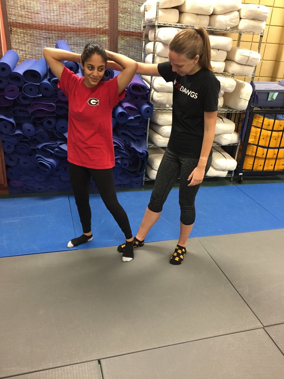 Victims steps on assailant's foot to disable her.