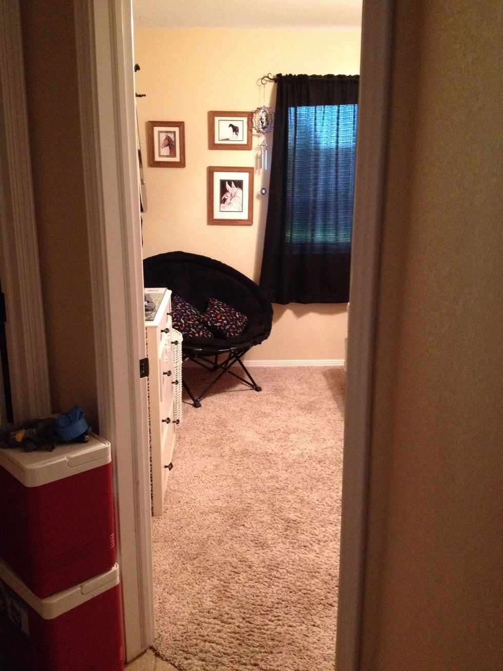 View from hallway. Nothing on floor and chair only has pillows.