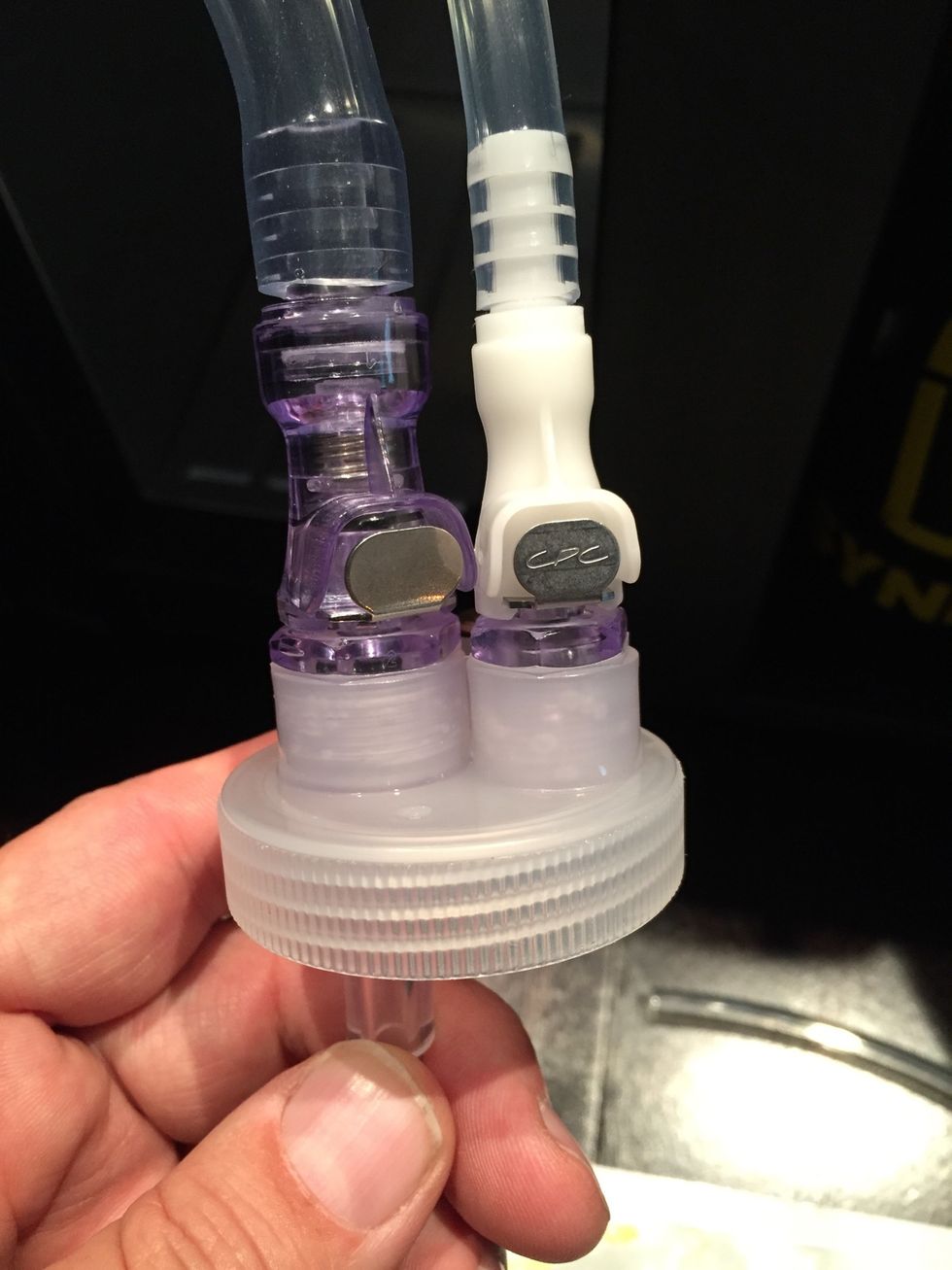 View of connected hoses. Press metal clips to disconnect them.