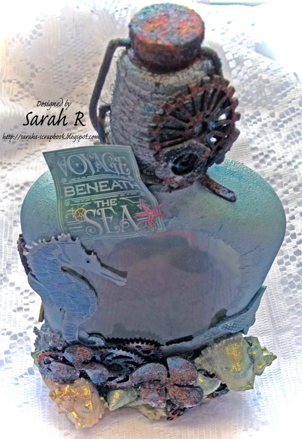 View of the top/front of the Mixed Media Altered Bottle.