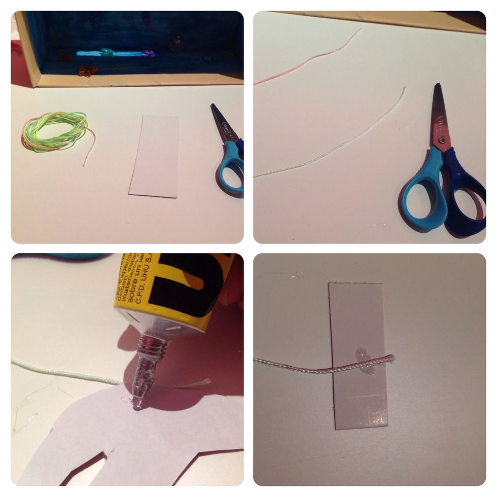 wa have a thread and scissors and cardboard-cut the string and cardboard into sections-keep little coots on cardboard and string