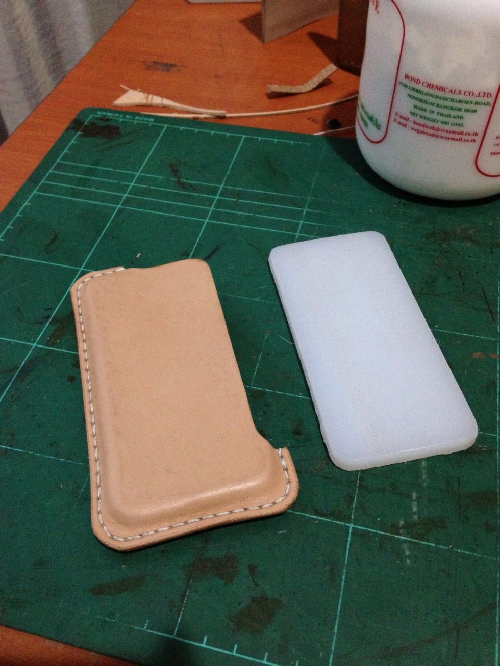 Wait a couple of hour or year (up to you) until it dry.. And took the plastic iphone off and try it on with your real iphone..