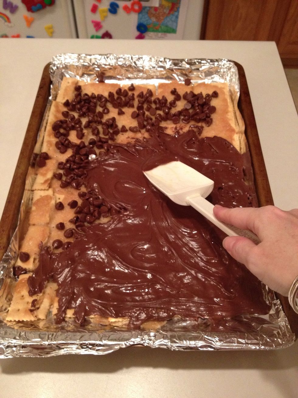 Wait a few minutes for the warm mixture to start melting the chocolate chips. Spread evenly with a spatula coated with cooking spray.