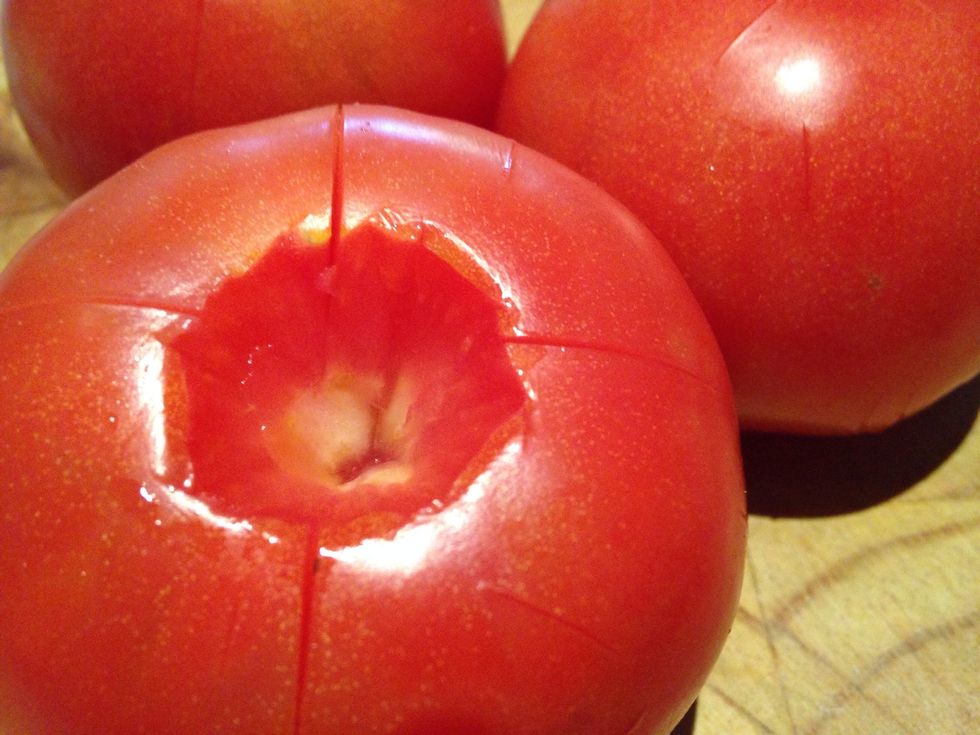 Wait five minutes, drain off the water and cover with cold water. Leave for another five minutes and then peel off the skins. Cut the tomatoes in half around their equator and scoop out the seeds.