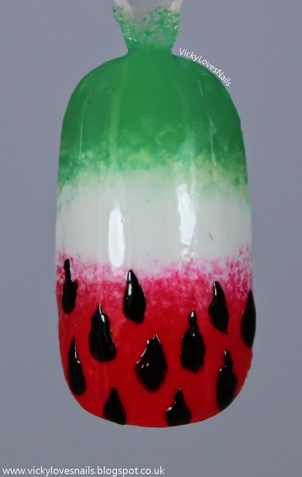 Wait for it to dry. Then get your detail brush to do the seeds. To it you must put a dollop of black polish on and drag ( only to do in the red area. If you don't have black use white it works well).