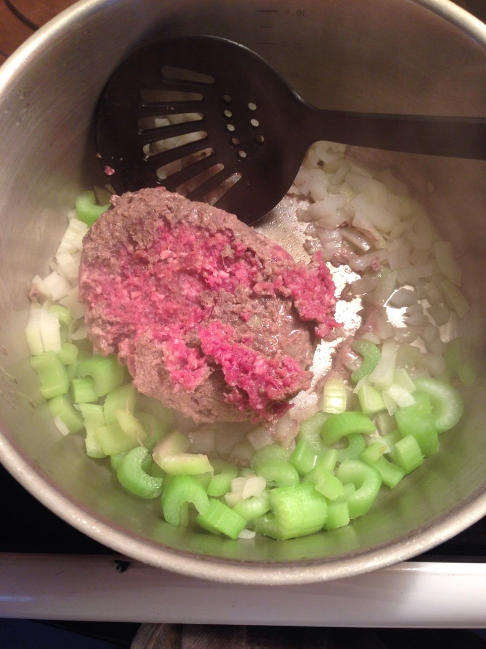 Wait for the outside of the beef to cook, then scrape it off and flip the beef that is still frozen.