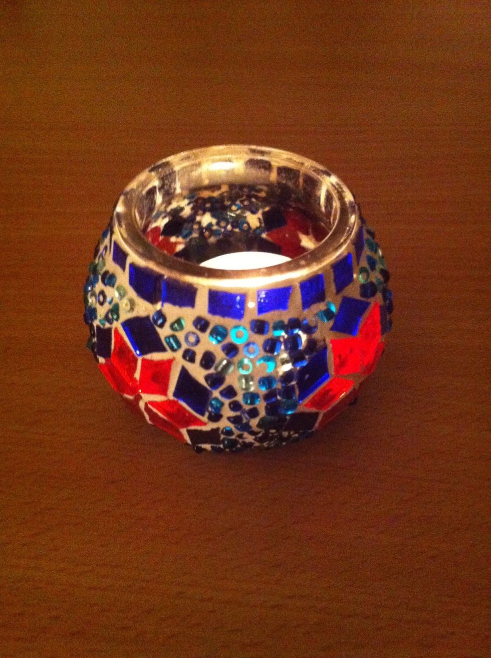 Wait for your candle to burn out. Clean it with hot water or your nails :)