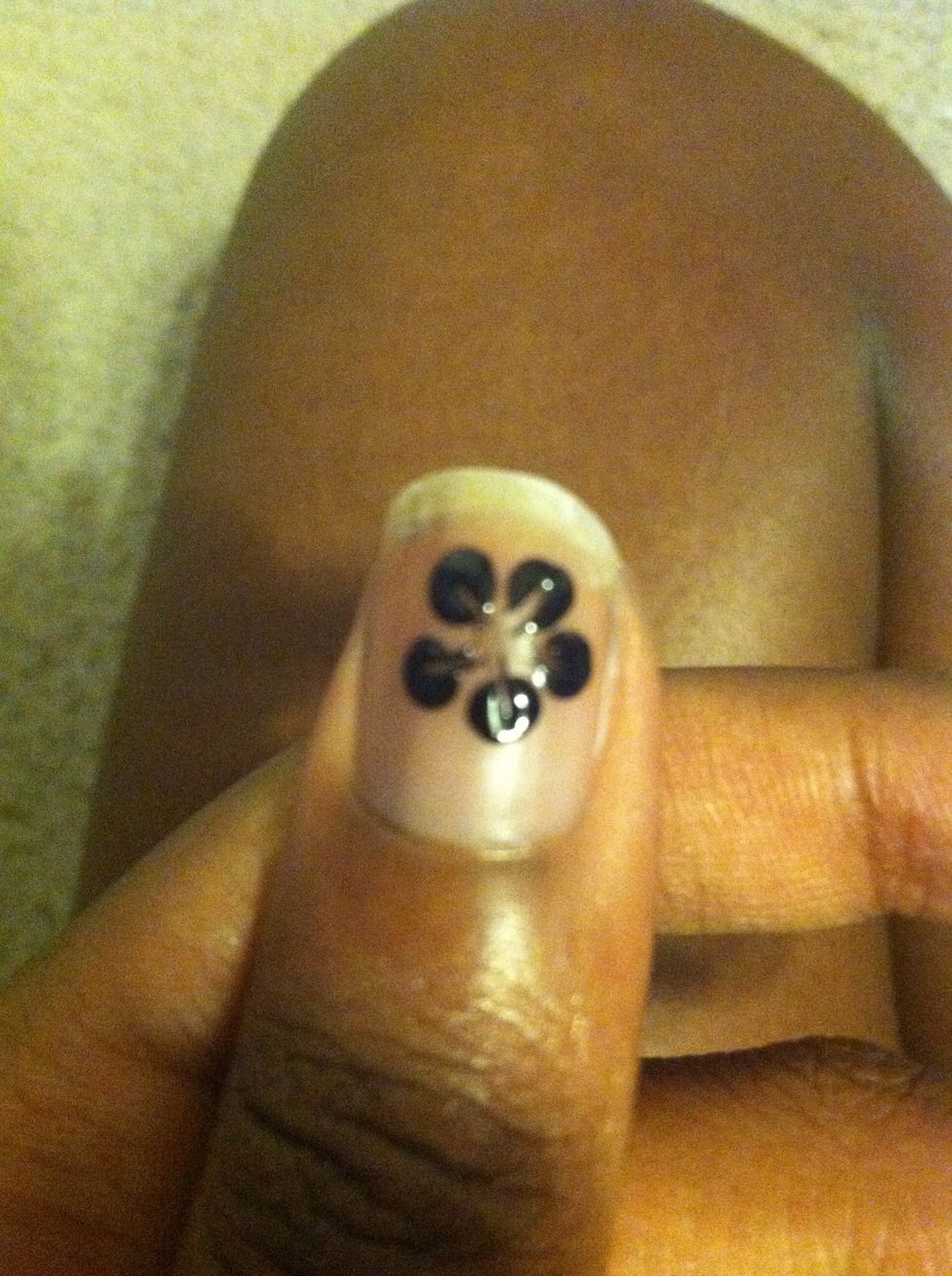 Wait til the polish gets tacky and Use the toothpick and drag each petal into the center like this\u2b06.