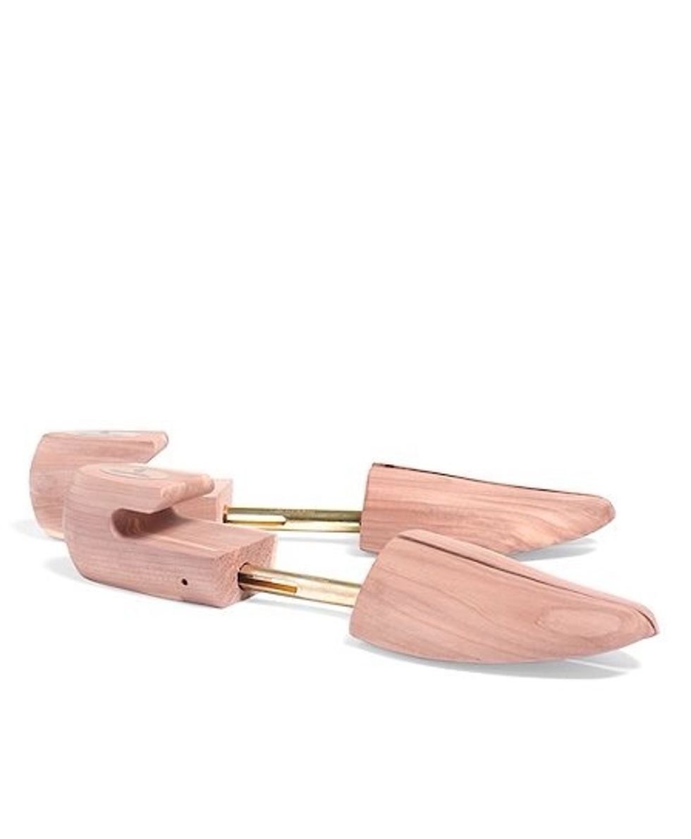 Wait until *most* of the water has been removed and then inset cedar shoe trees (not plastic ones). This will preserve the shape of the shoes, absorb left over moisture, and prevent mildew.