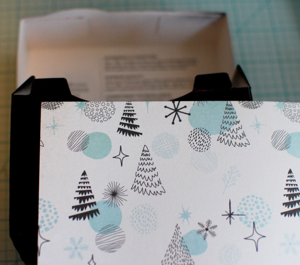 Wait until the box is fully dry. Grab the Garland Sheet. Place it on top of each side of the box and mark where to cut. I left about 1/16\u201d of an inch on the outer edges. This way, the black will show.