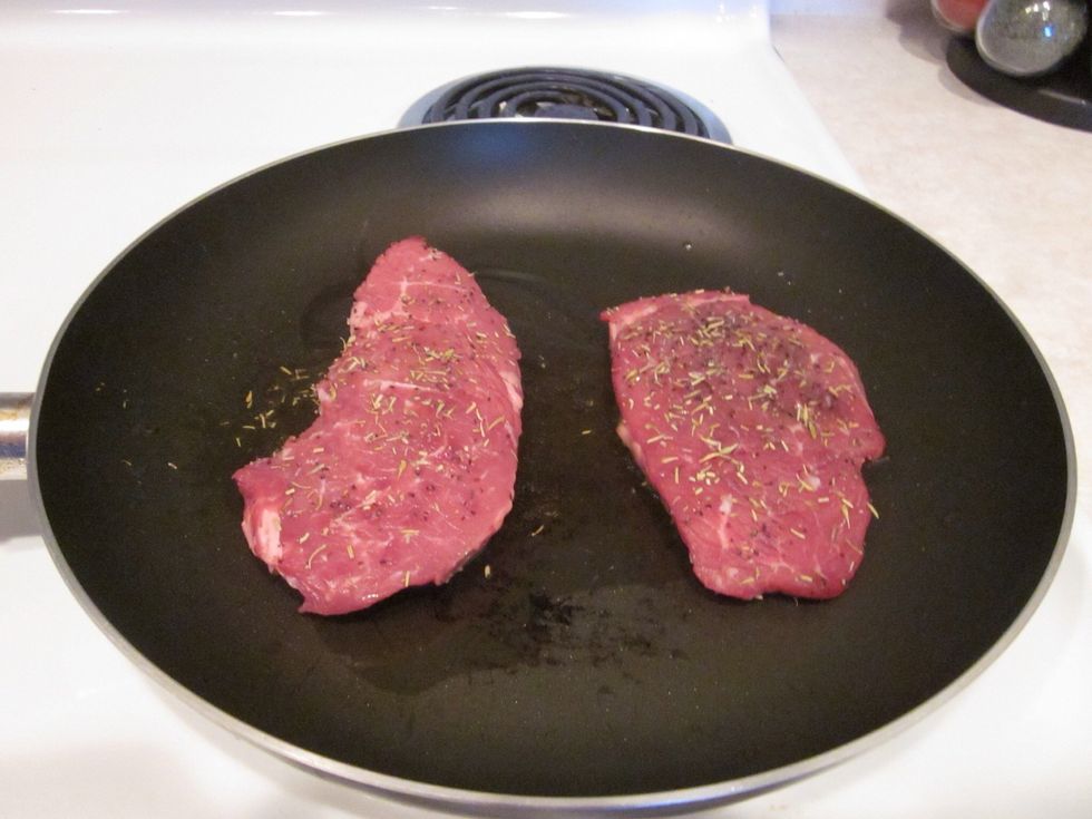 Wait until the olive oil starts to smoke just a little bit. Reduce the heat a bit and plop your steak in the pan. Once it's down, do NOT touch it. Just let it go baby!!